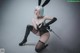 A woman in a bunny costume holding a sword.