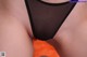 A close up of a person wearing a black thong.