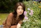 A woman sitting in a field of flowers.