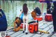 A group of people standing on top of a wooden dock.