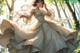 A woman in a wedding dress in the woods.